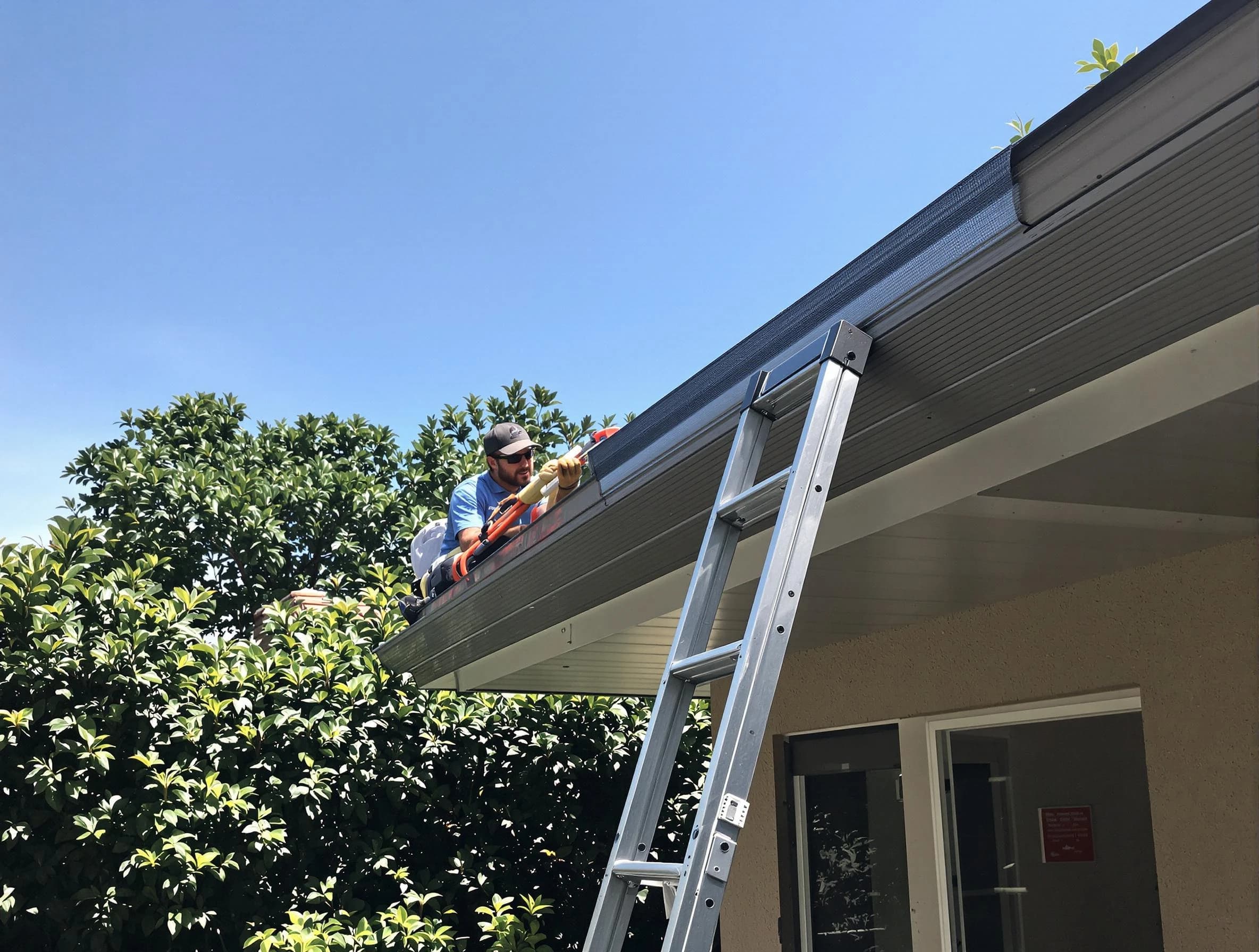 Warrensville Heights Roofing Company installing gutter guards for a homeowner in Warrensville Heights, OH